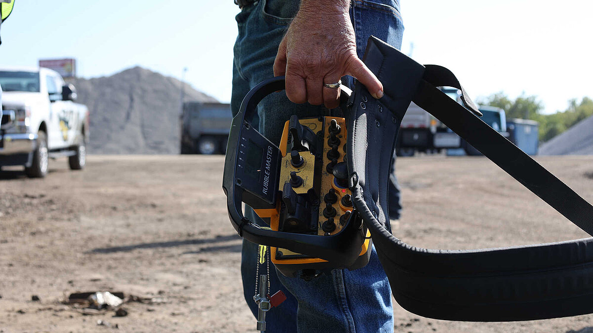 Crusher Operator with Radio Remote Control in Hands